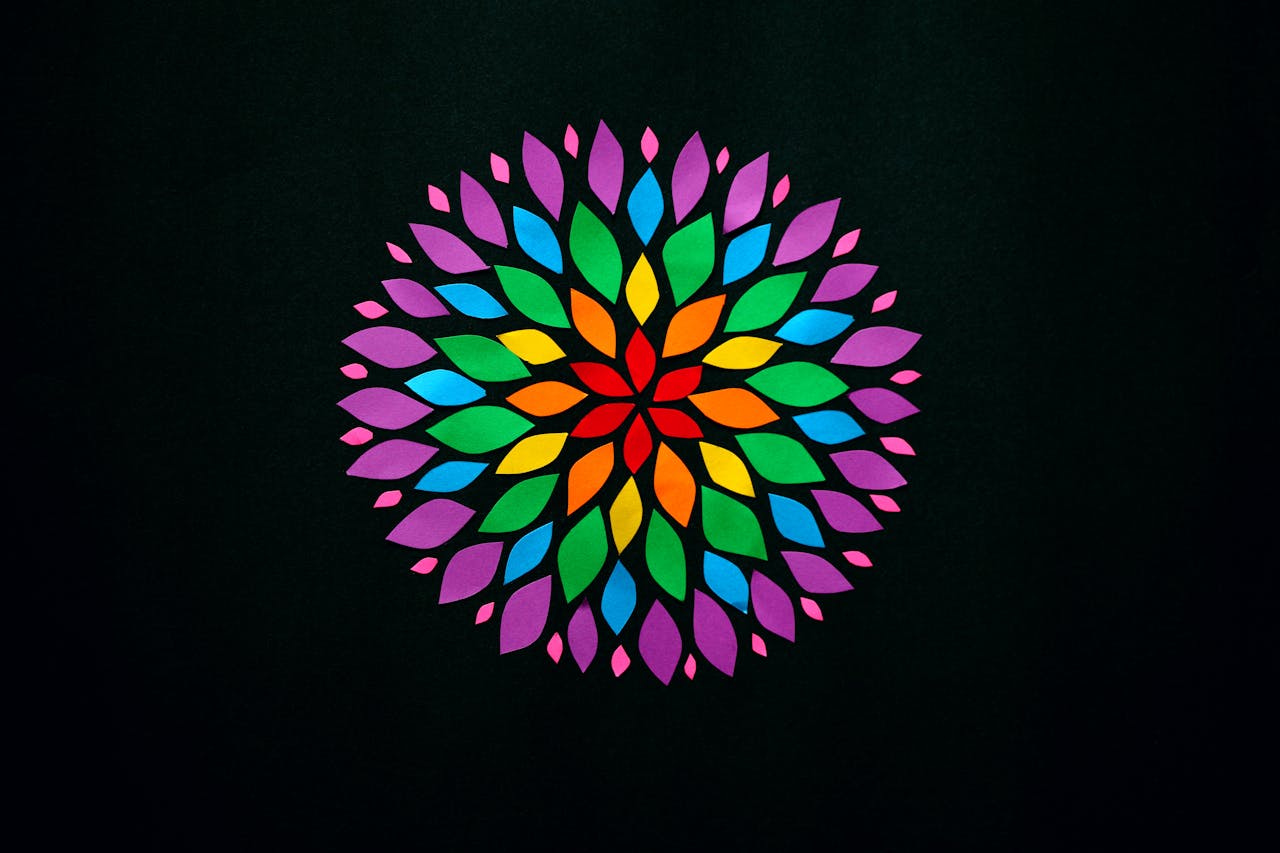 Colorful mandala artwork with symmetrical patterns on a black background, perfect for creative design projects.
